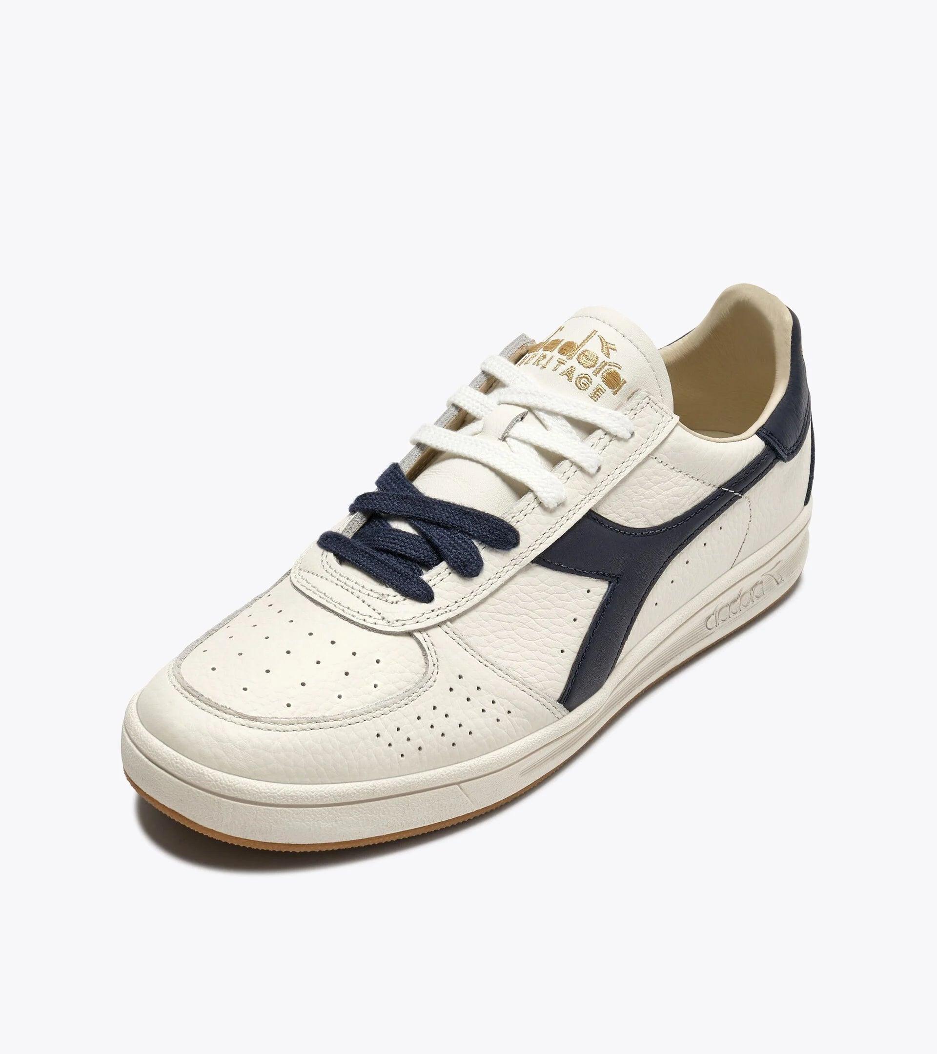 B. ELITE Dominio | White/Peacoat | DIADORA